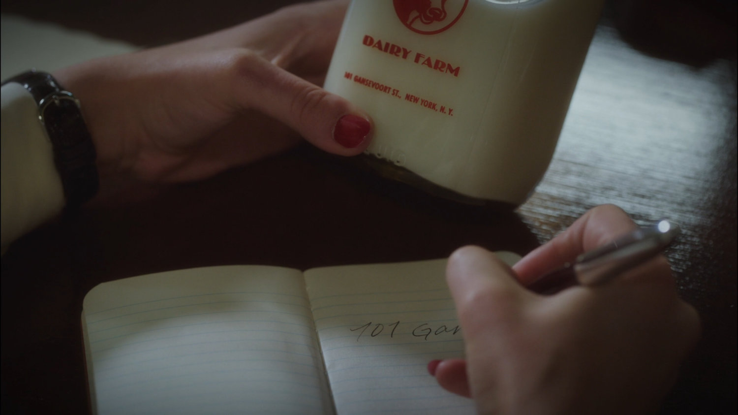 Closeup Daisy Clover milk bottle and address.