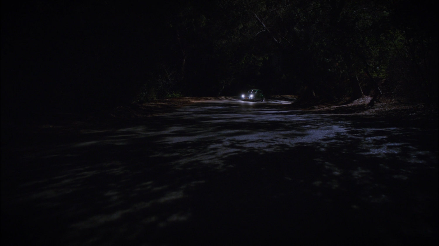 Car on a dark, twisty New Jersey road.