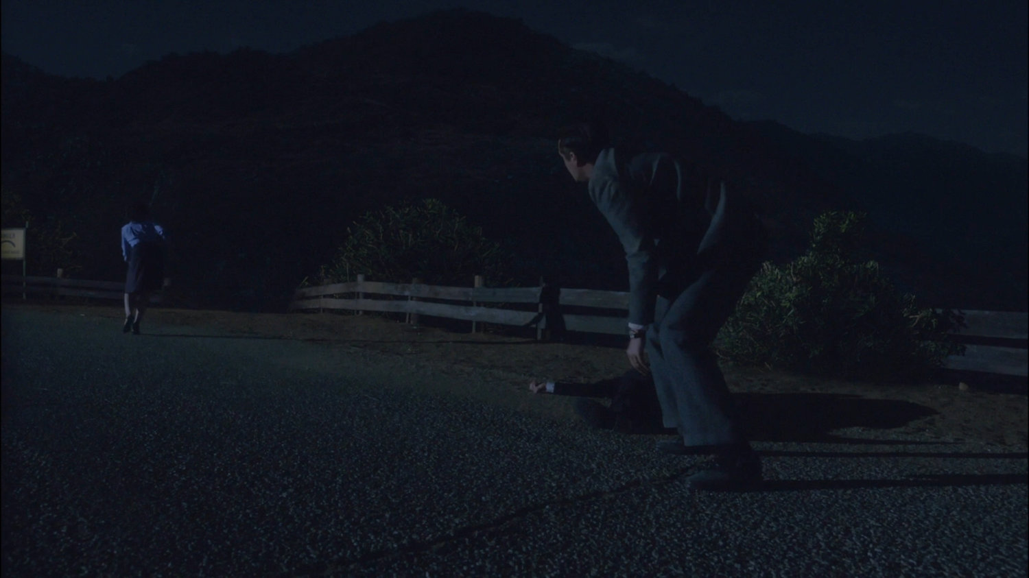 Jarvis and Peggy looking at broken guard rail.
