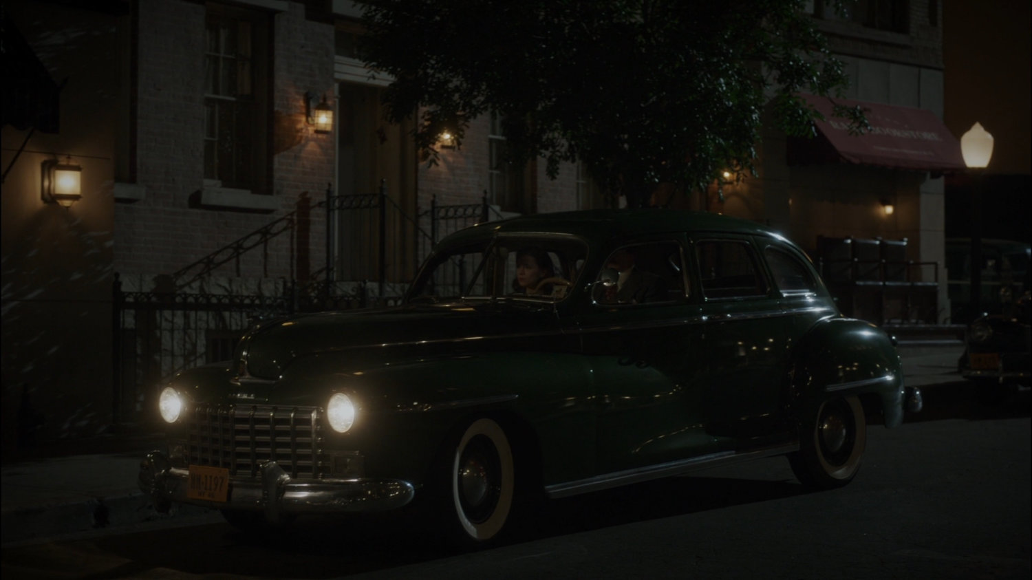 Car on dark New York city street.