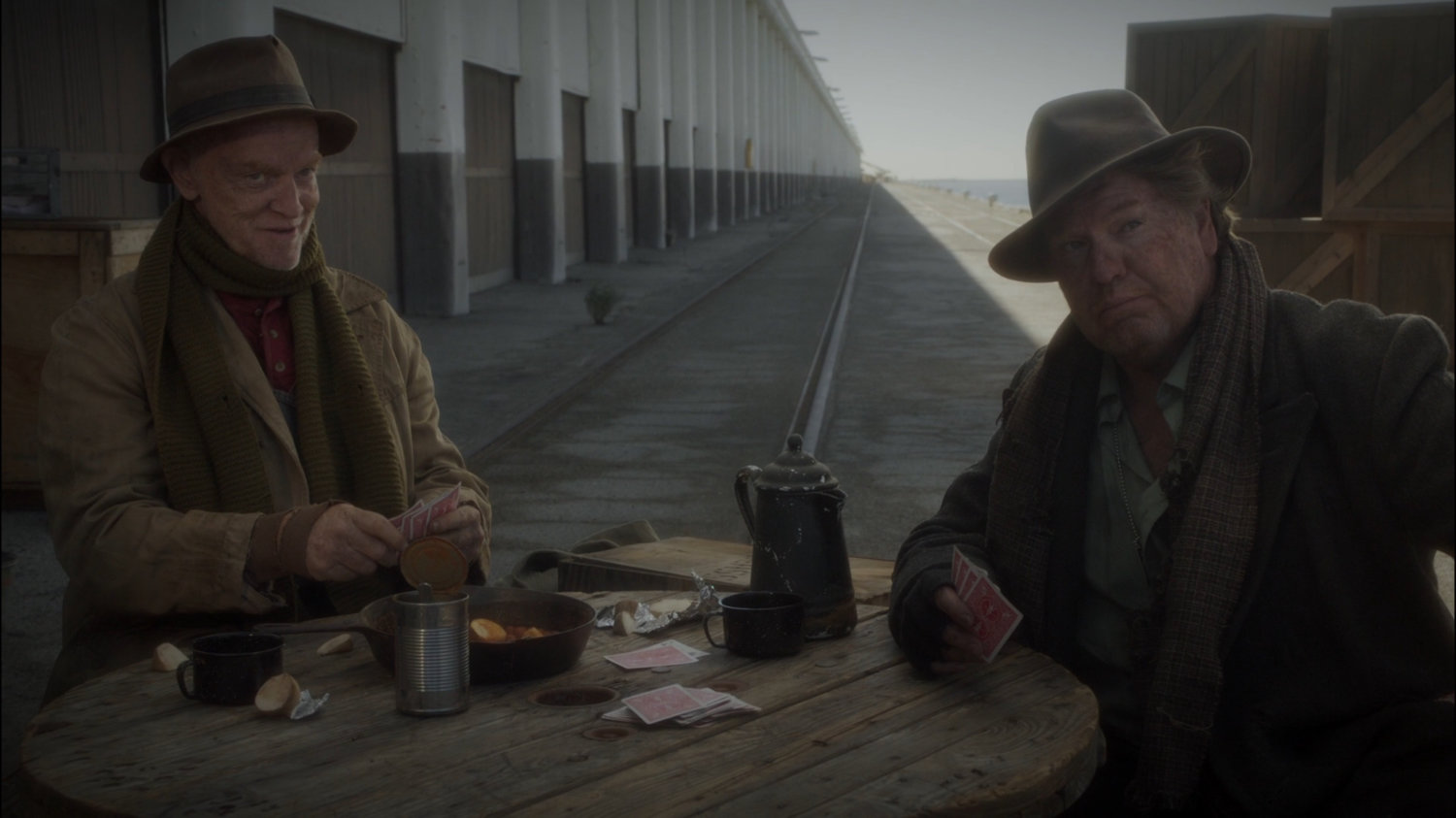 Two hobo's play cards on Dock 12.