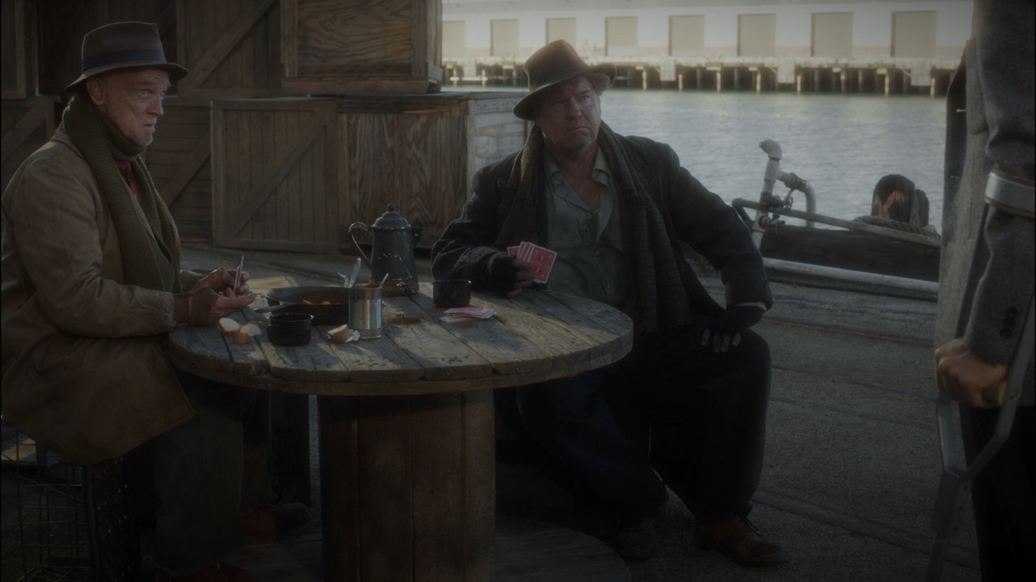 Two hobo's play cards on Dock 12.