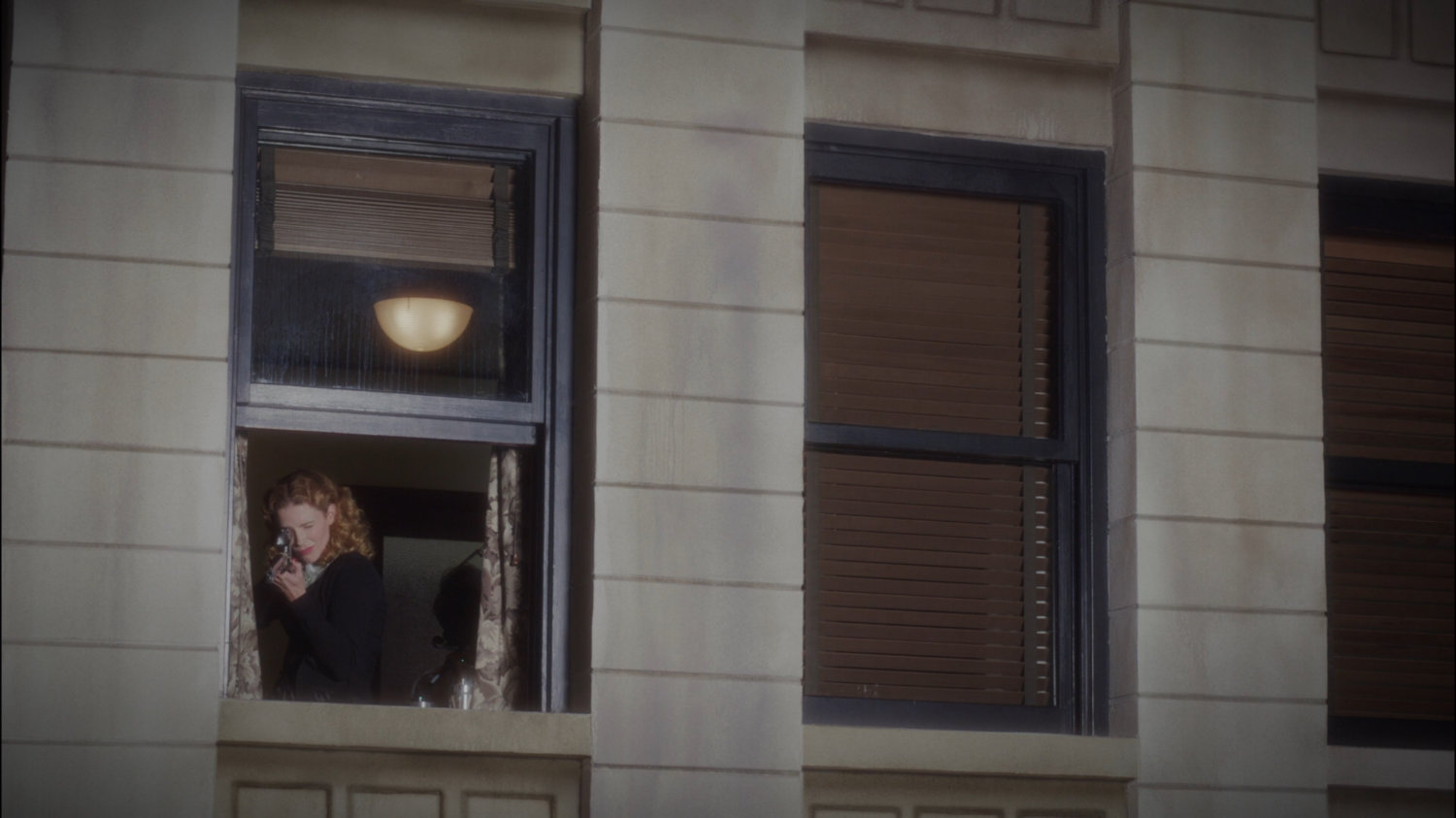 Dottie with rifle in window of Dentist Office.