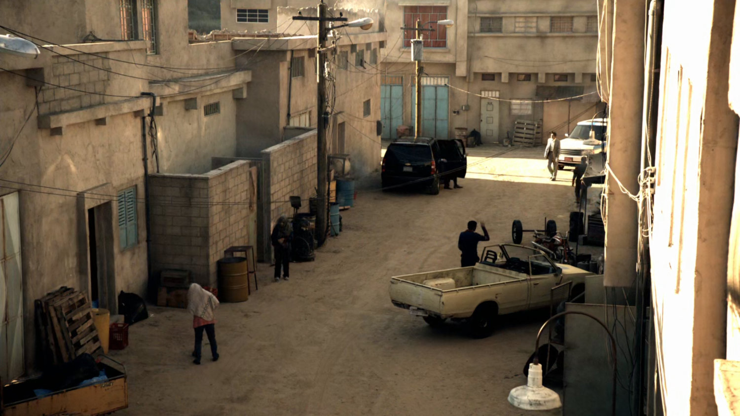 Agents exit a black SUV on dirt street in Bahrain.