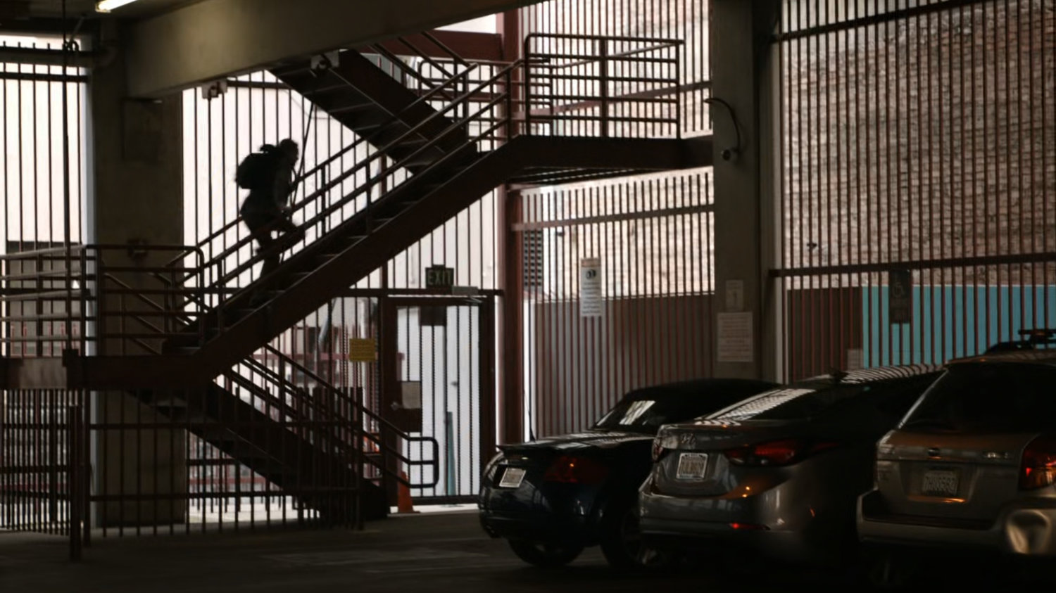 Fitz running up parking garage stairs.