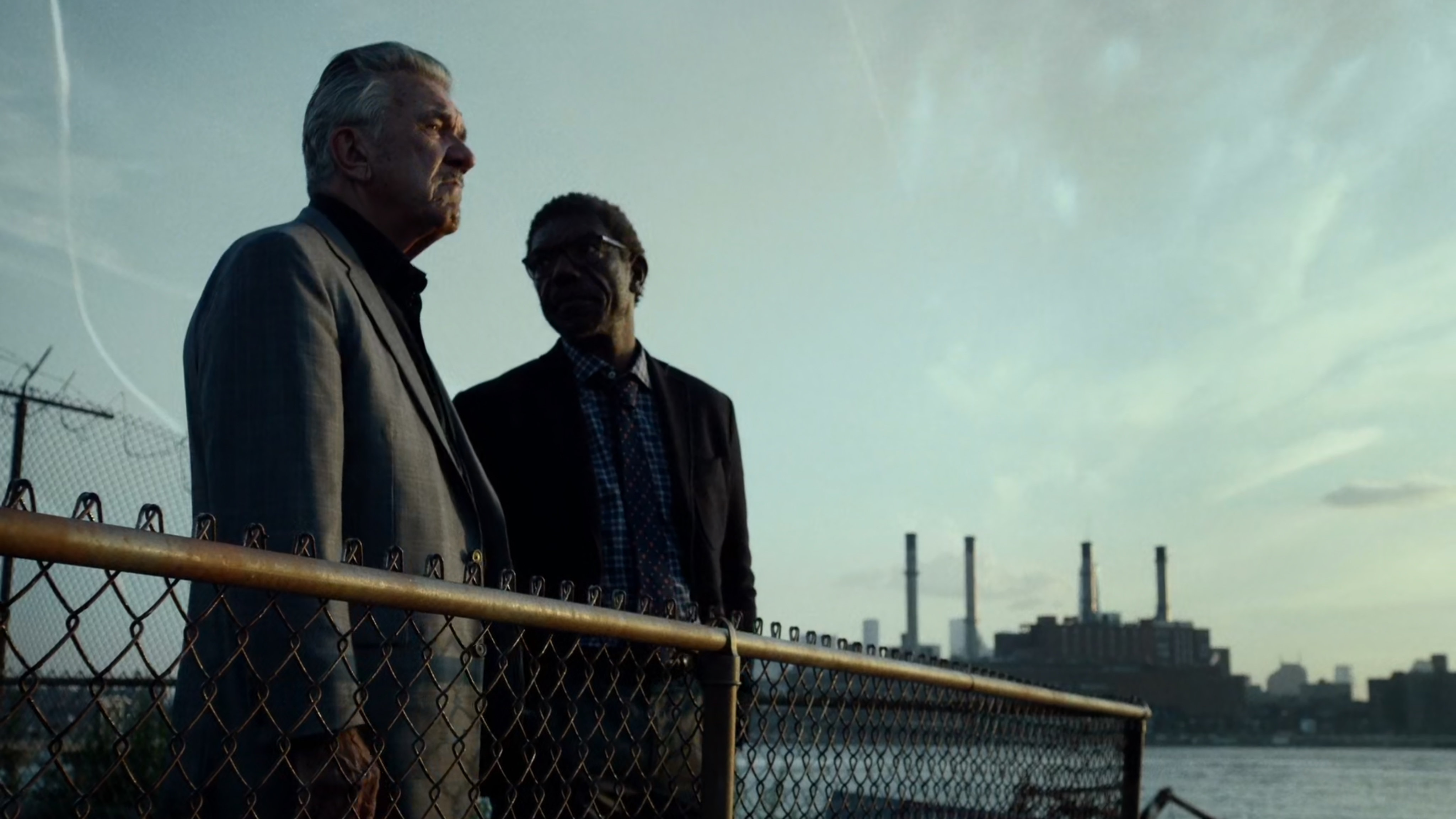 Ben and Silvio talk in river side lot.