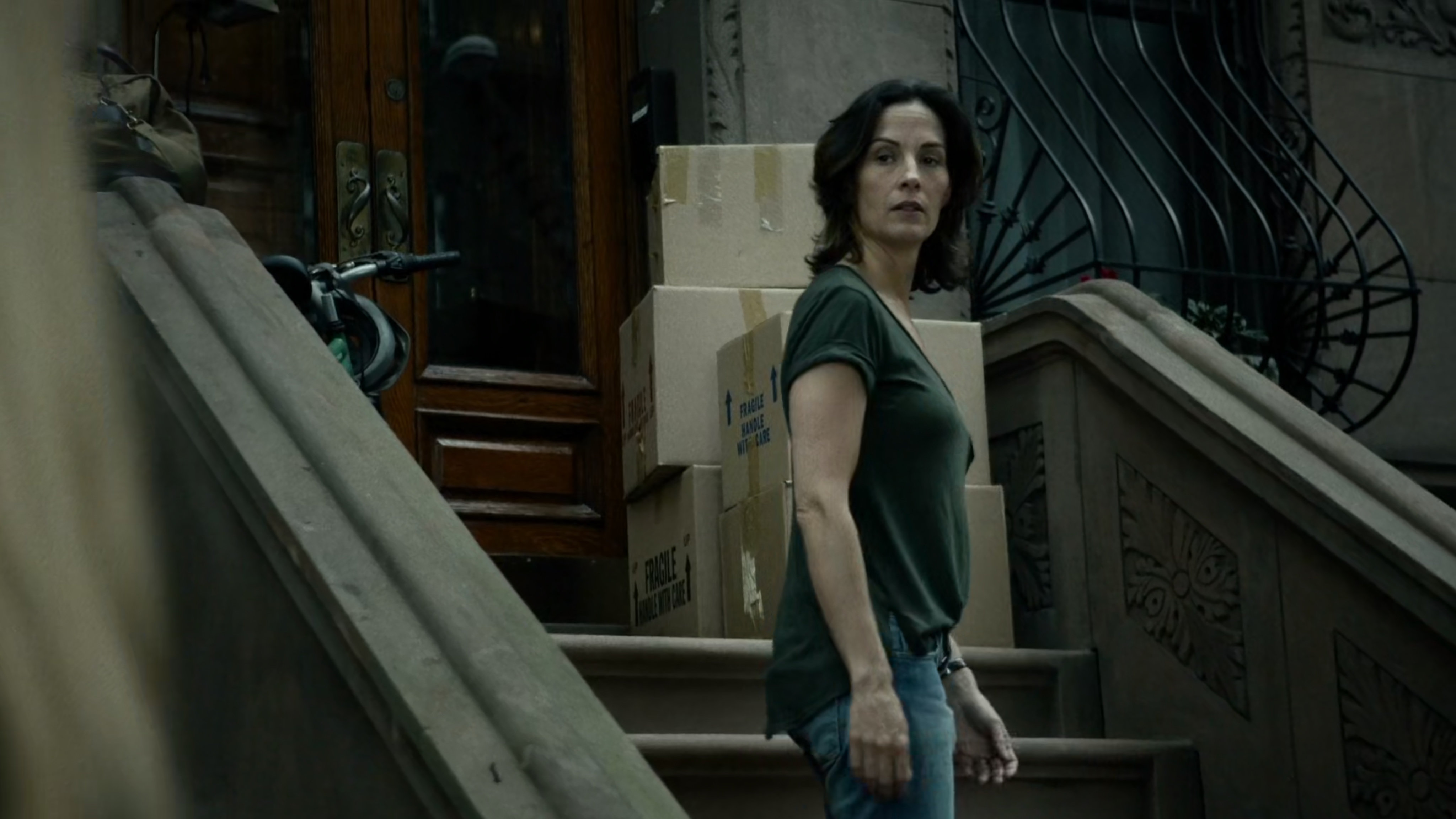 Mrs Fisher on steps of brownstone.