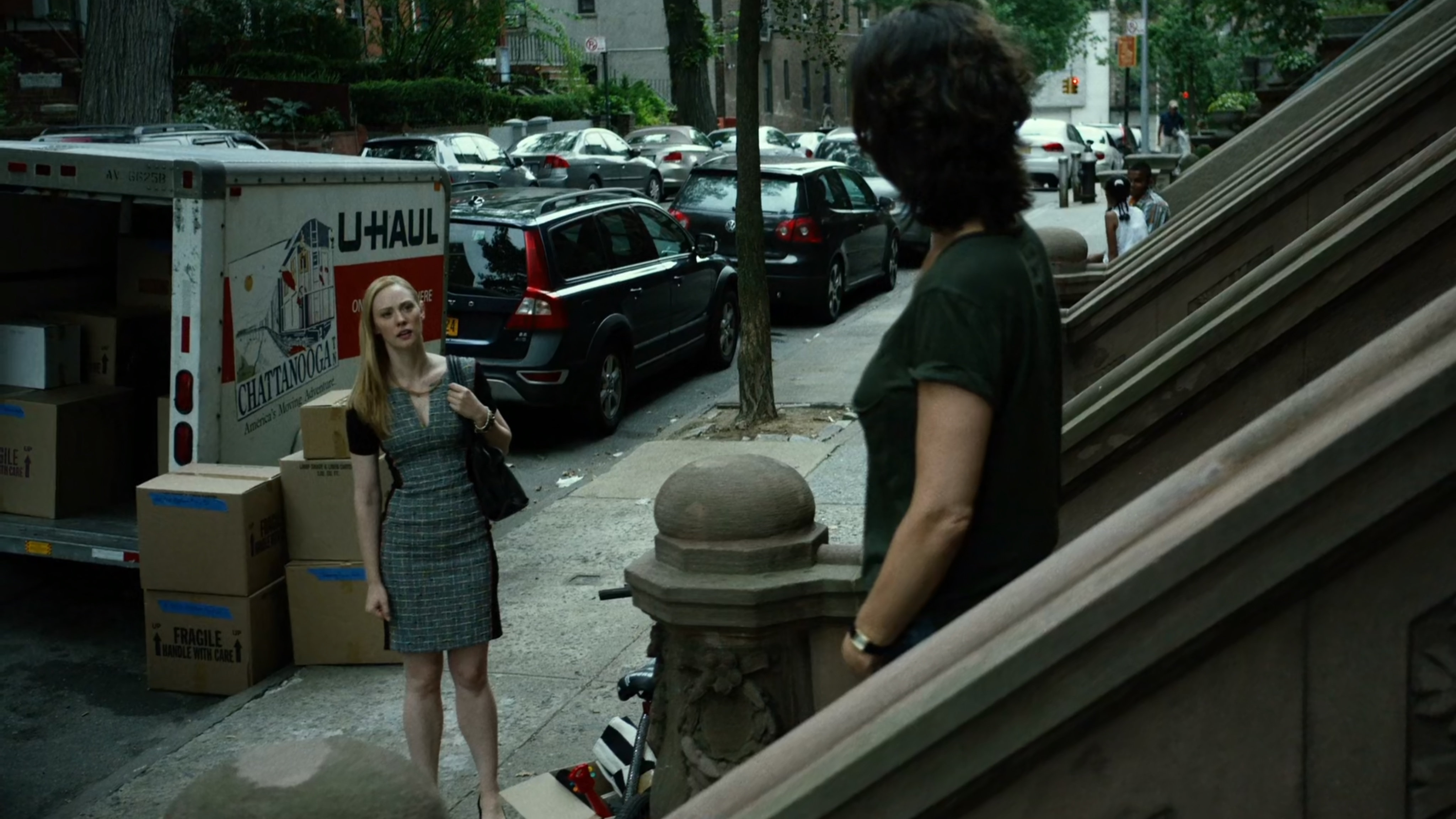 Karen talks to Mrs Fisher on steps of brownstone.