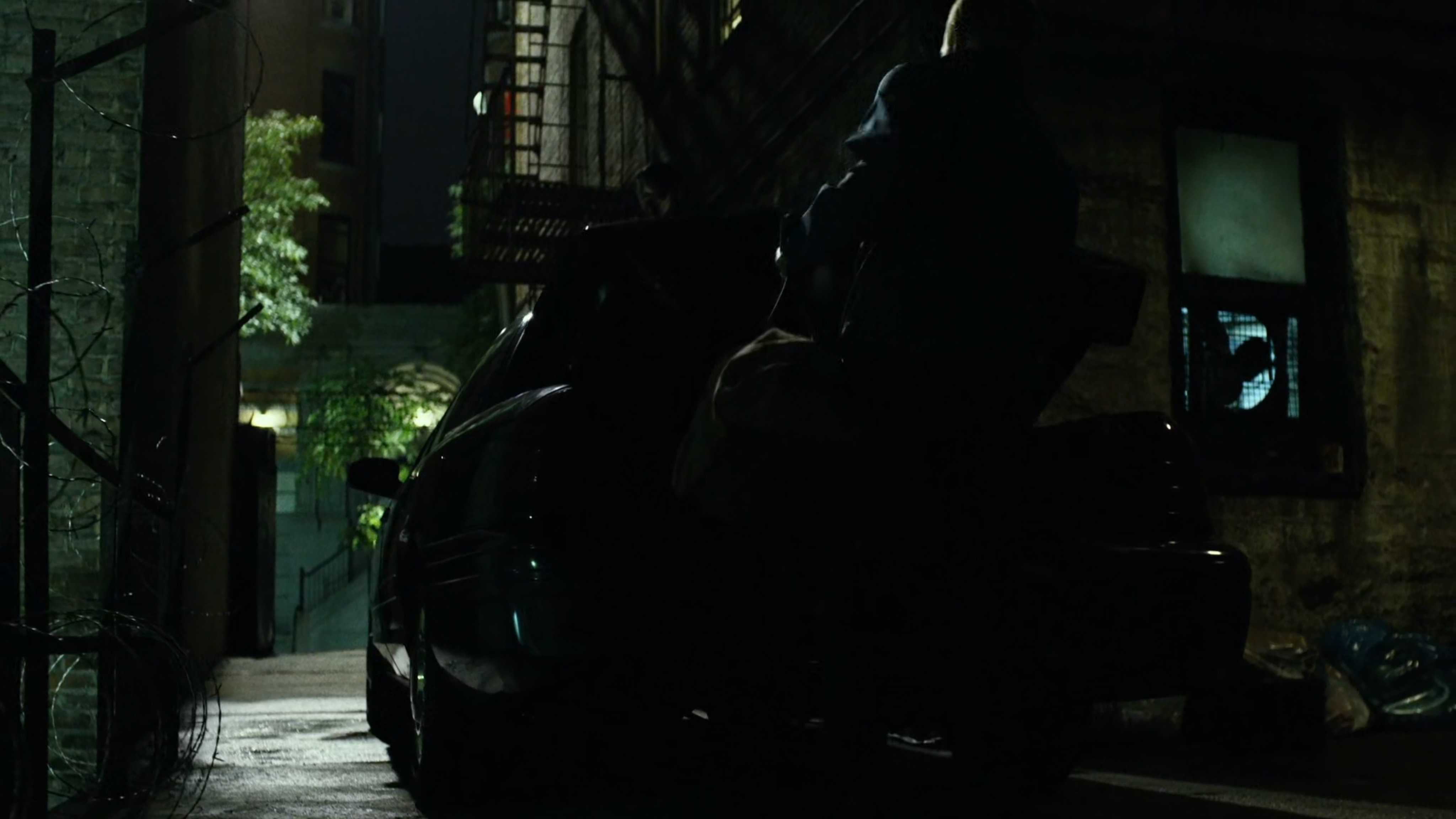 Daredevil fights Healy in dark alley.