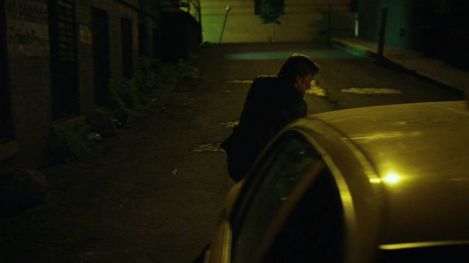 Anatoly on phone in alley getting into cab.