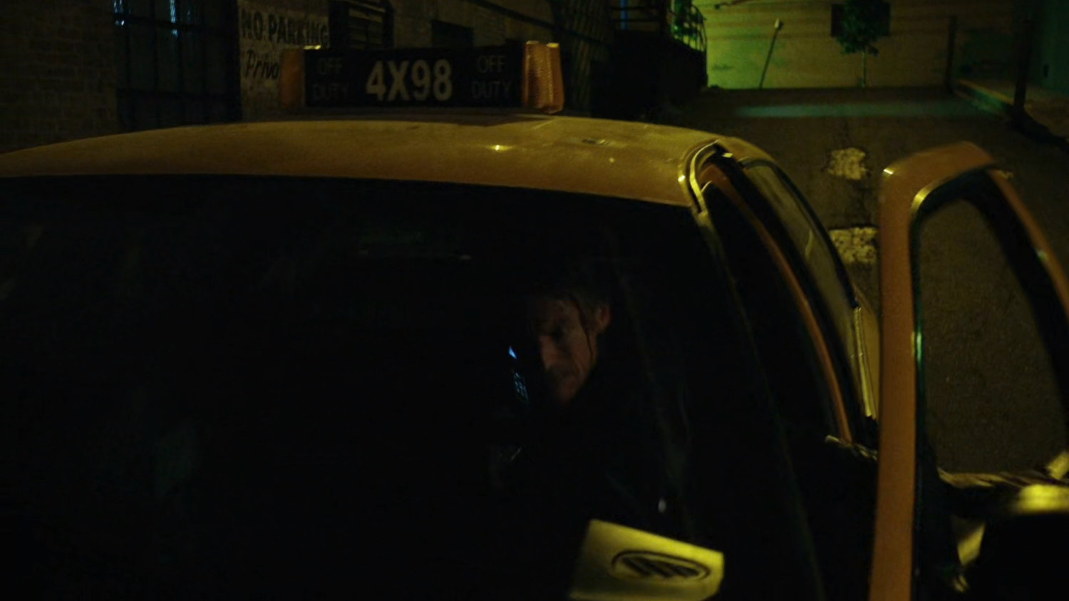 Anatoly on phone in alley getting into cab.