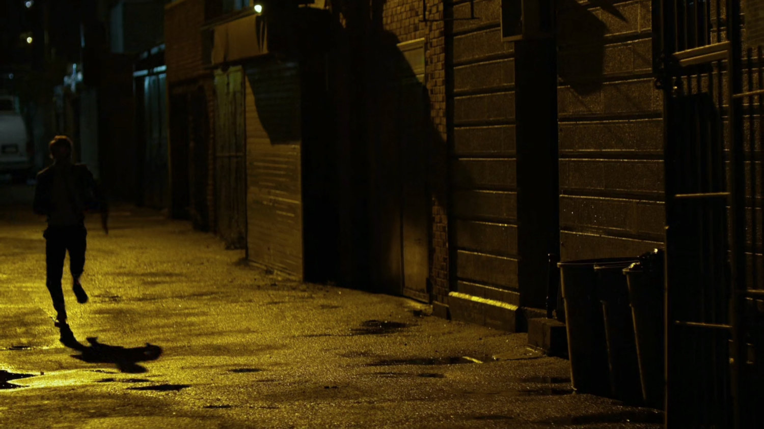 Matt runs through alley outside Claire's co-worker's apartment.