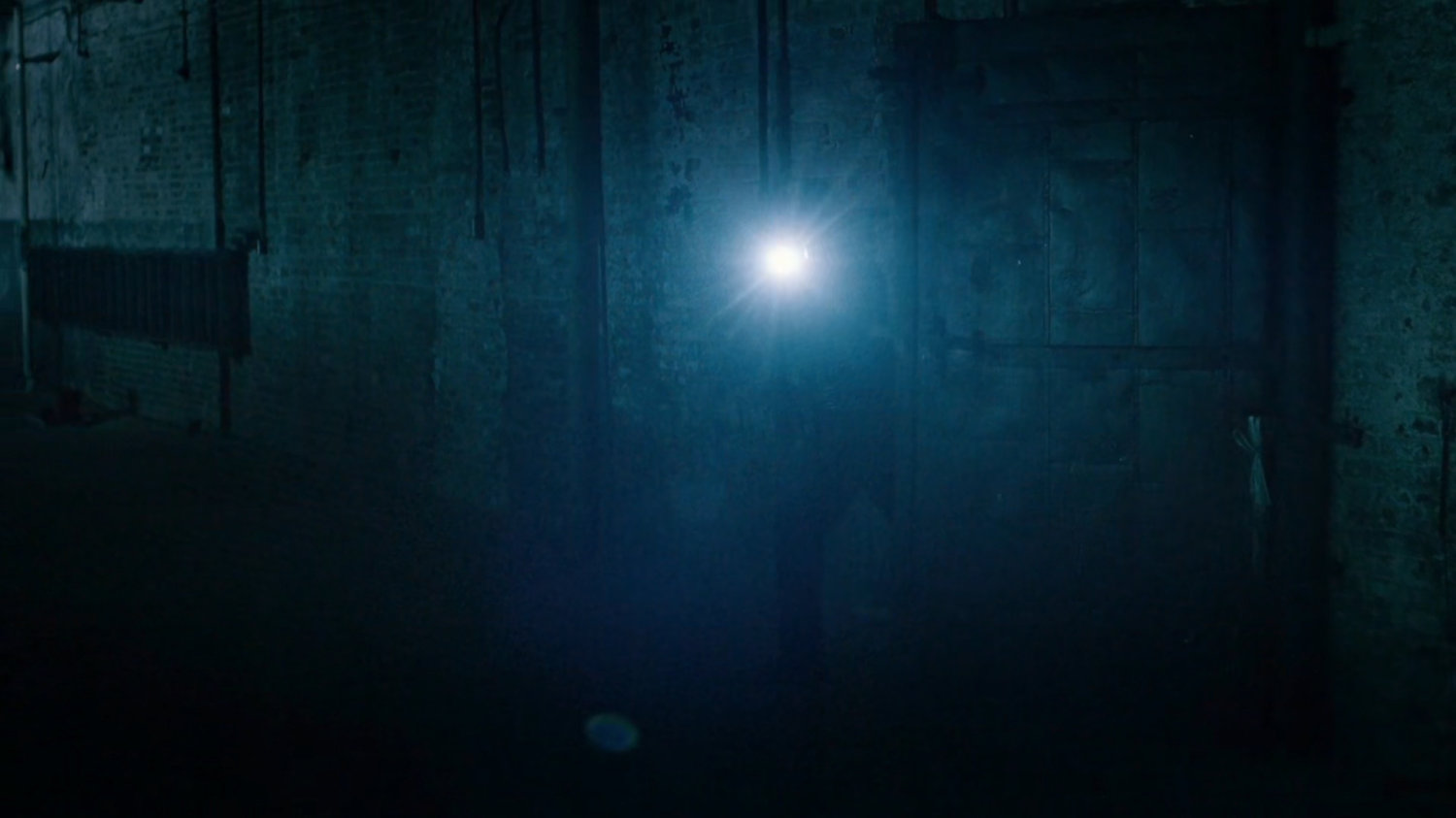 Police officer inside abandoned warehouse.