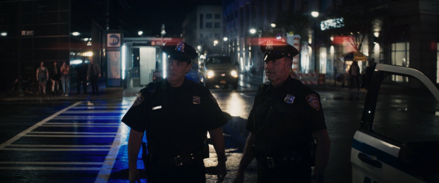 Police officers outside motorcycle showroom.