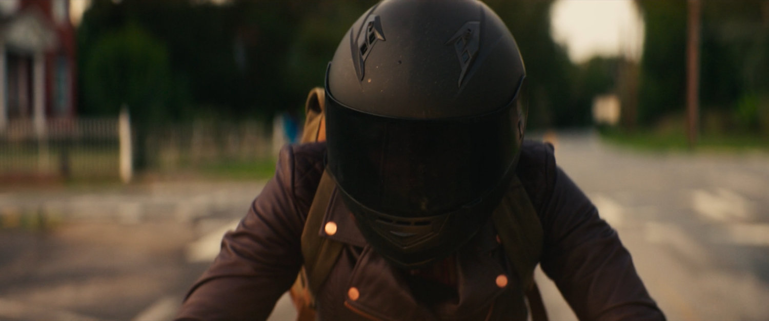 Closeup of Maya on her motorcycle in downtown Tamaha.