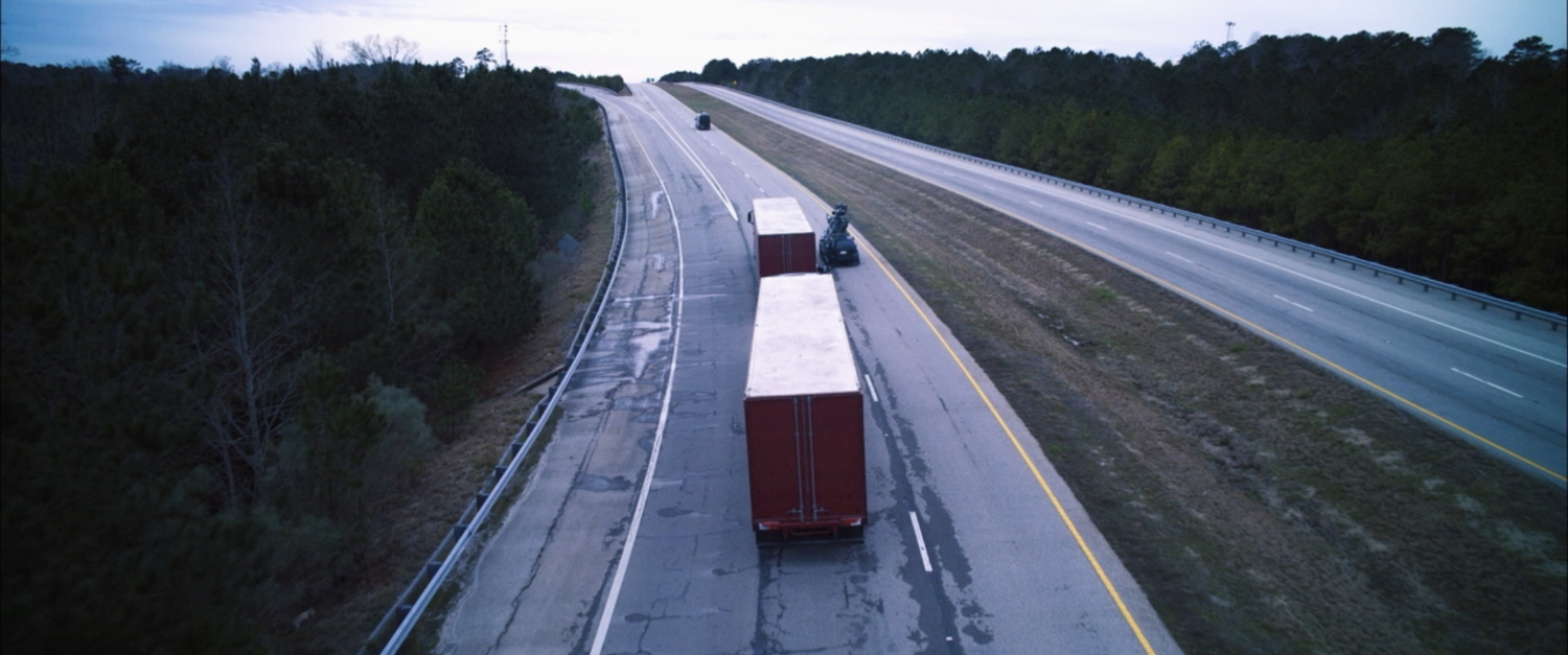 Behind the scenes view of trucks on a Georgia interstate.
