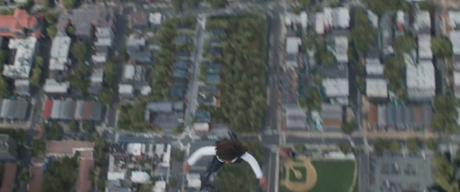 Monica flying above Jersey City baseball field.