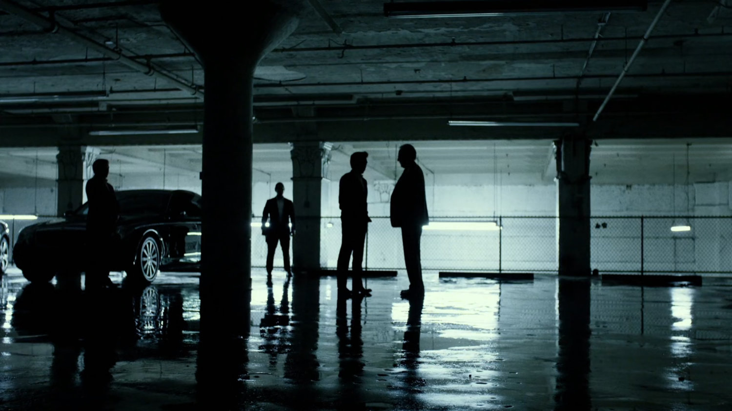 Nobu and Owlsley in stark white parking garage.
