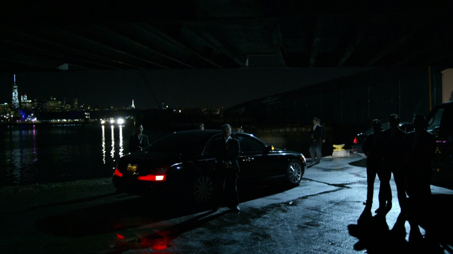 Members of Yakuza standing at docks where Black Sky is being delivered.