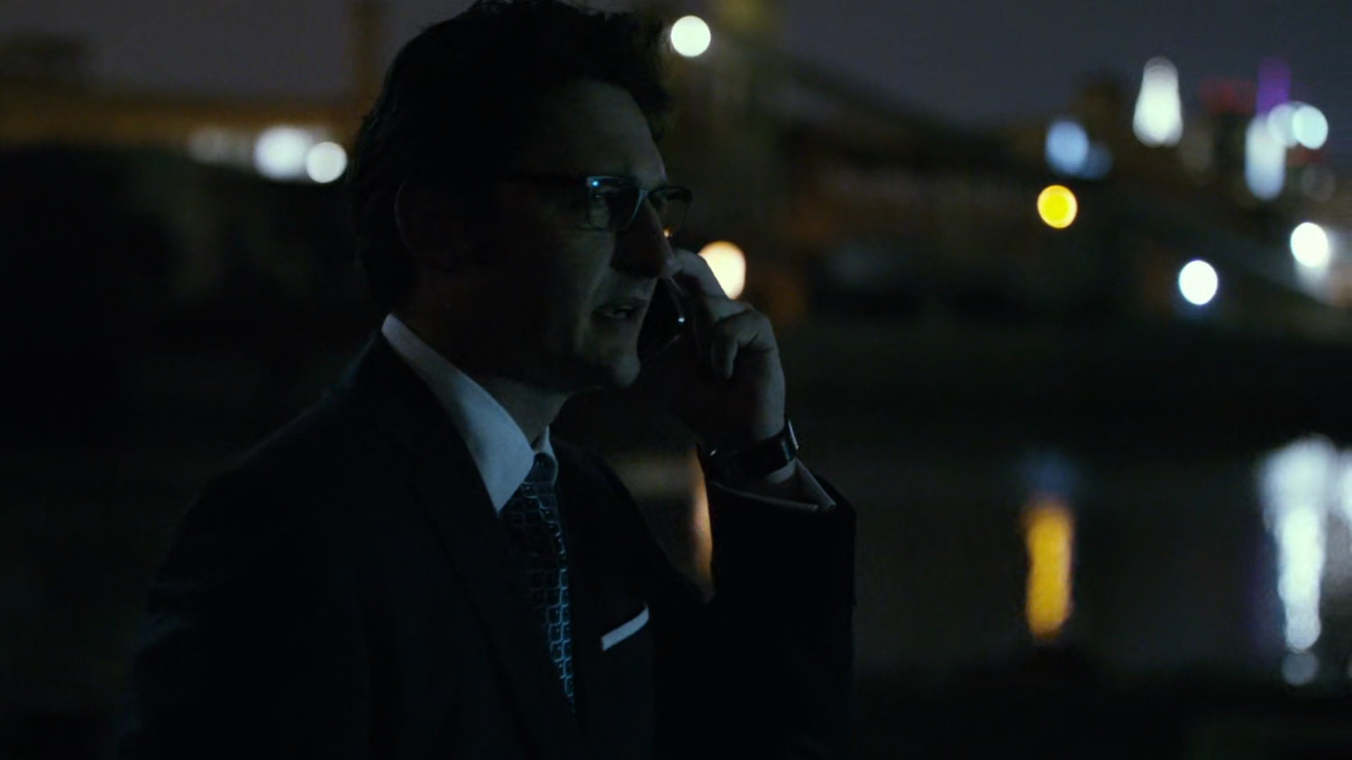 Wesley on phone walking near docks.