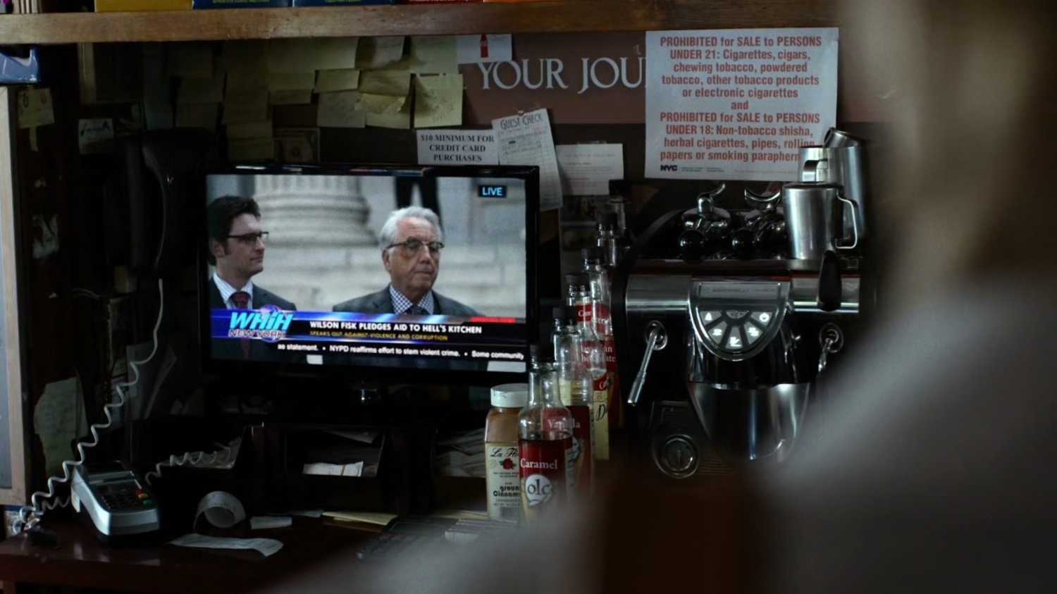 Interior of bodega with Wilson Fisk televised press conference.