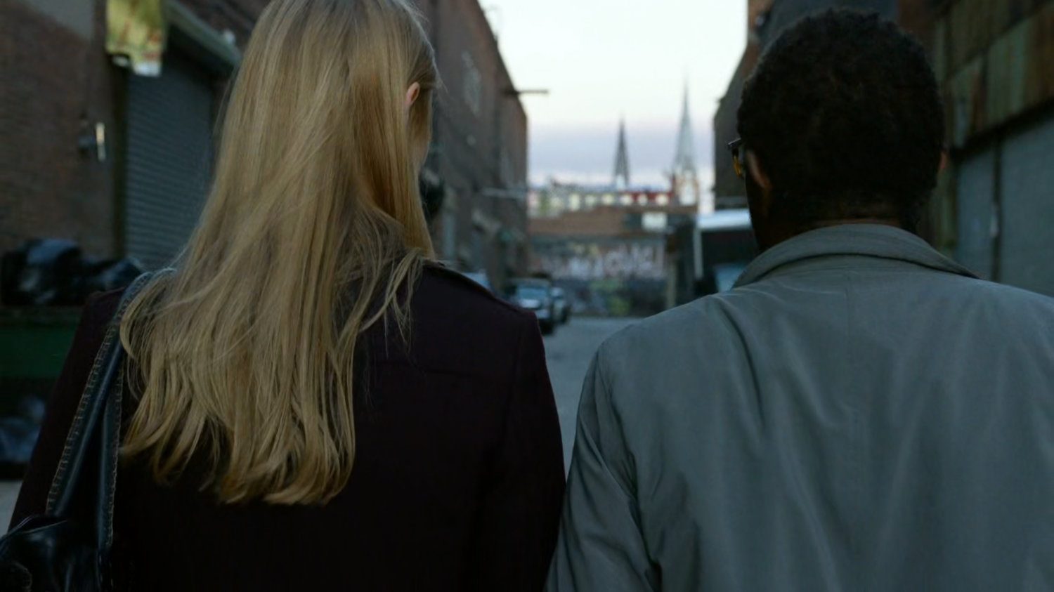 Karen and Ben walking down an alley.