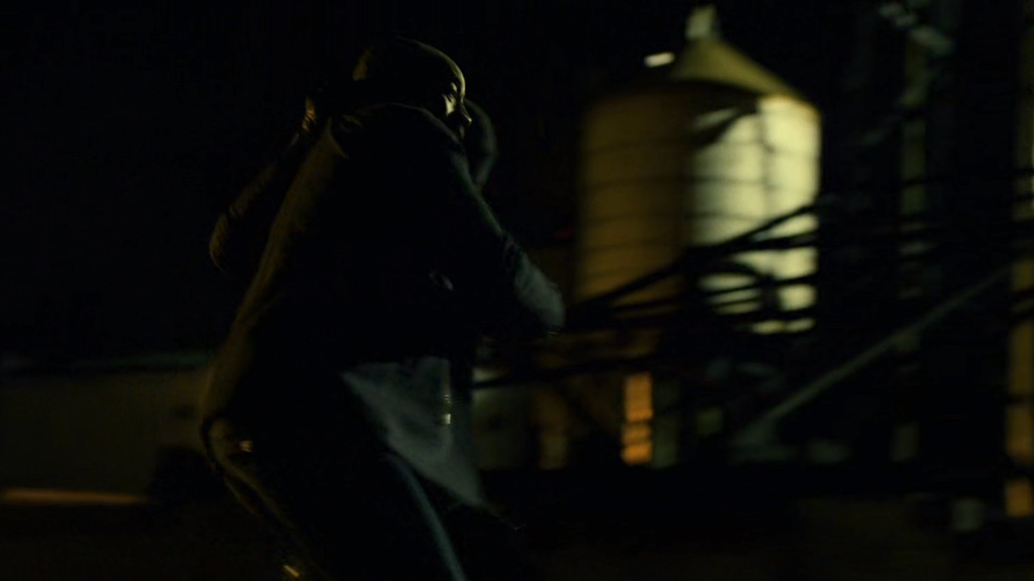 Turk on a dark rooftop.