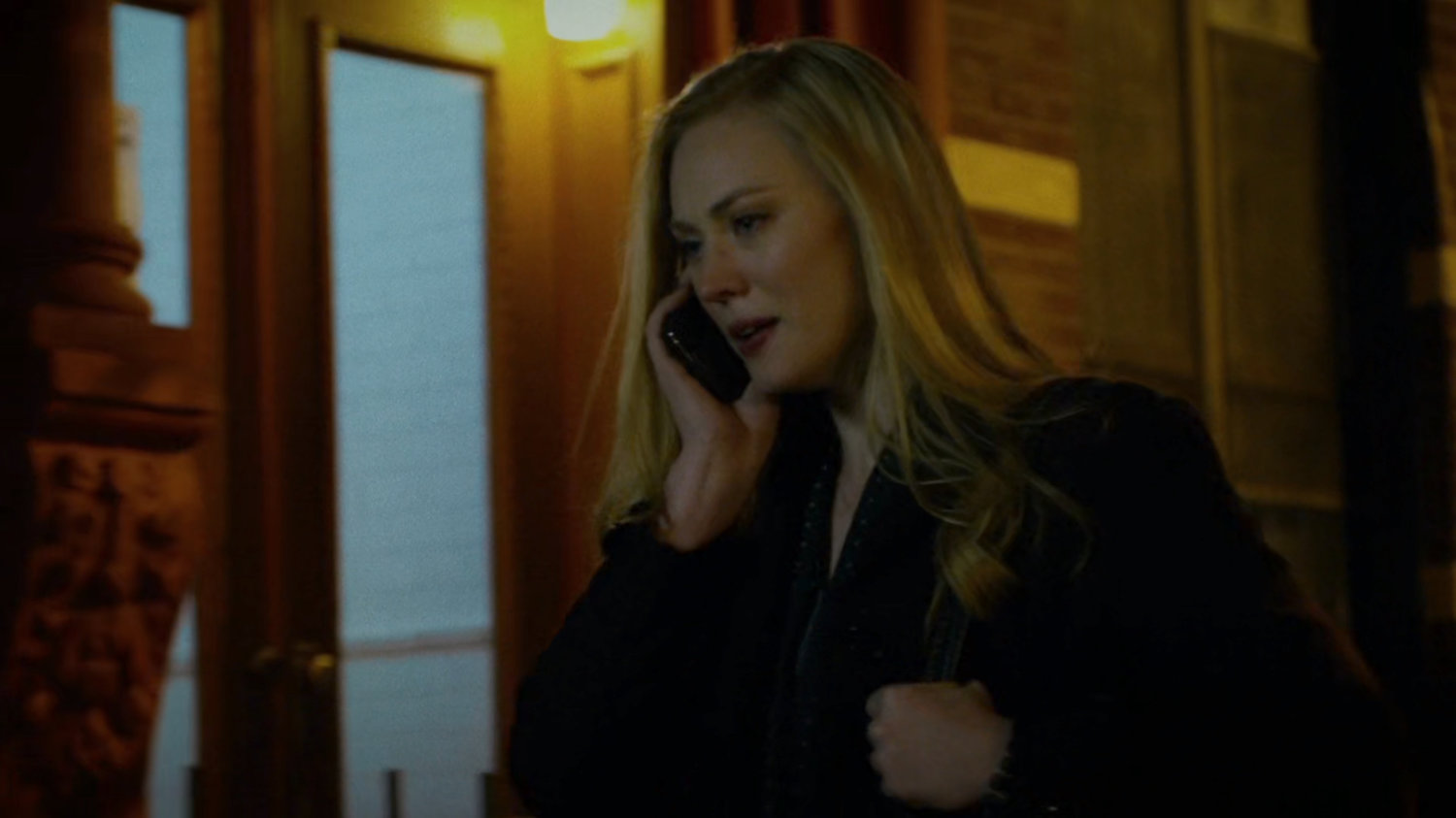 Karen talking on the phone while walking on sidewalk.