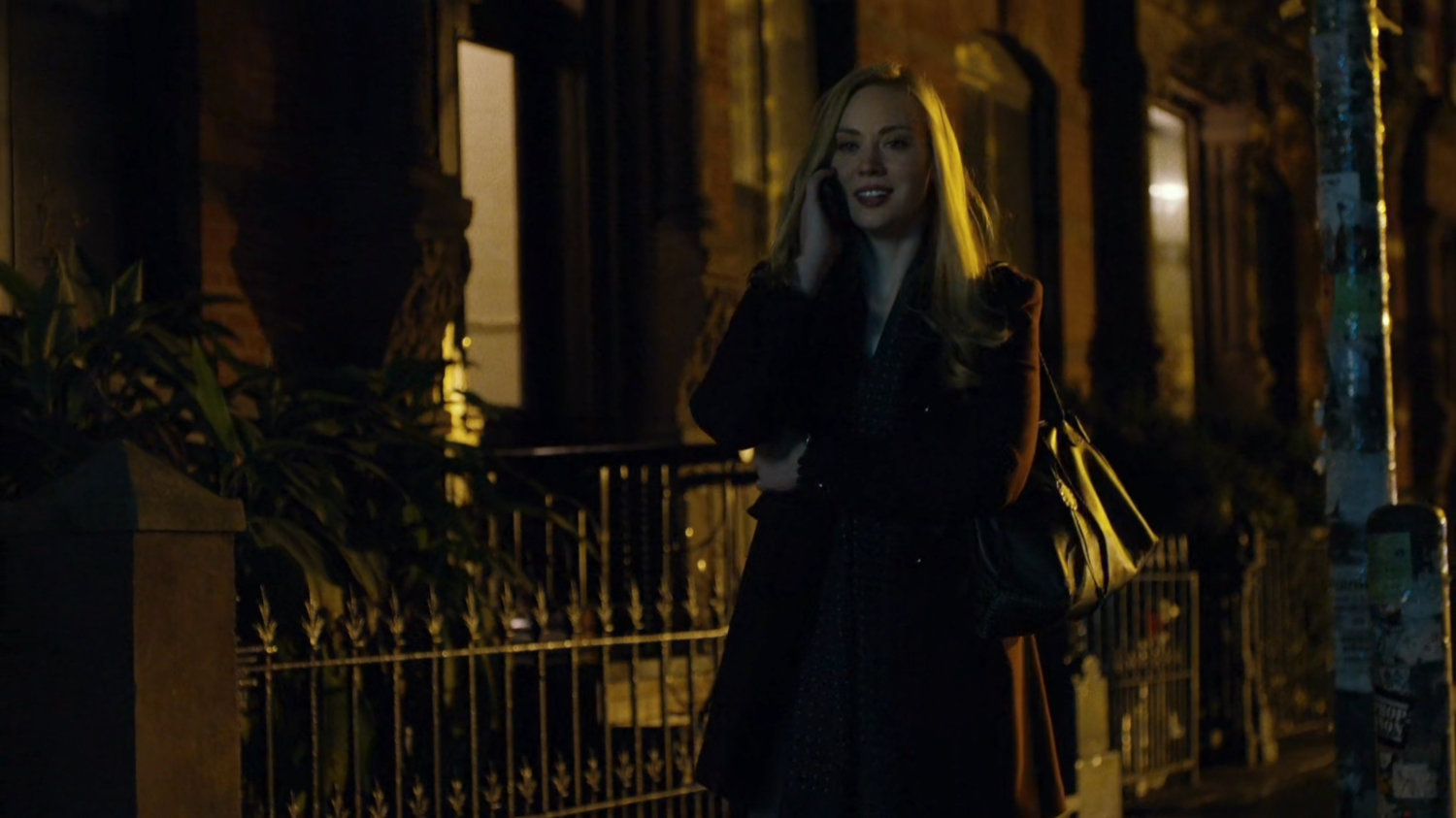 Karen talking on the phone while walking on sidewalk.