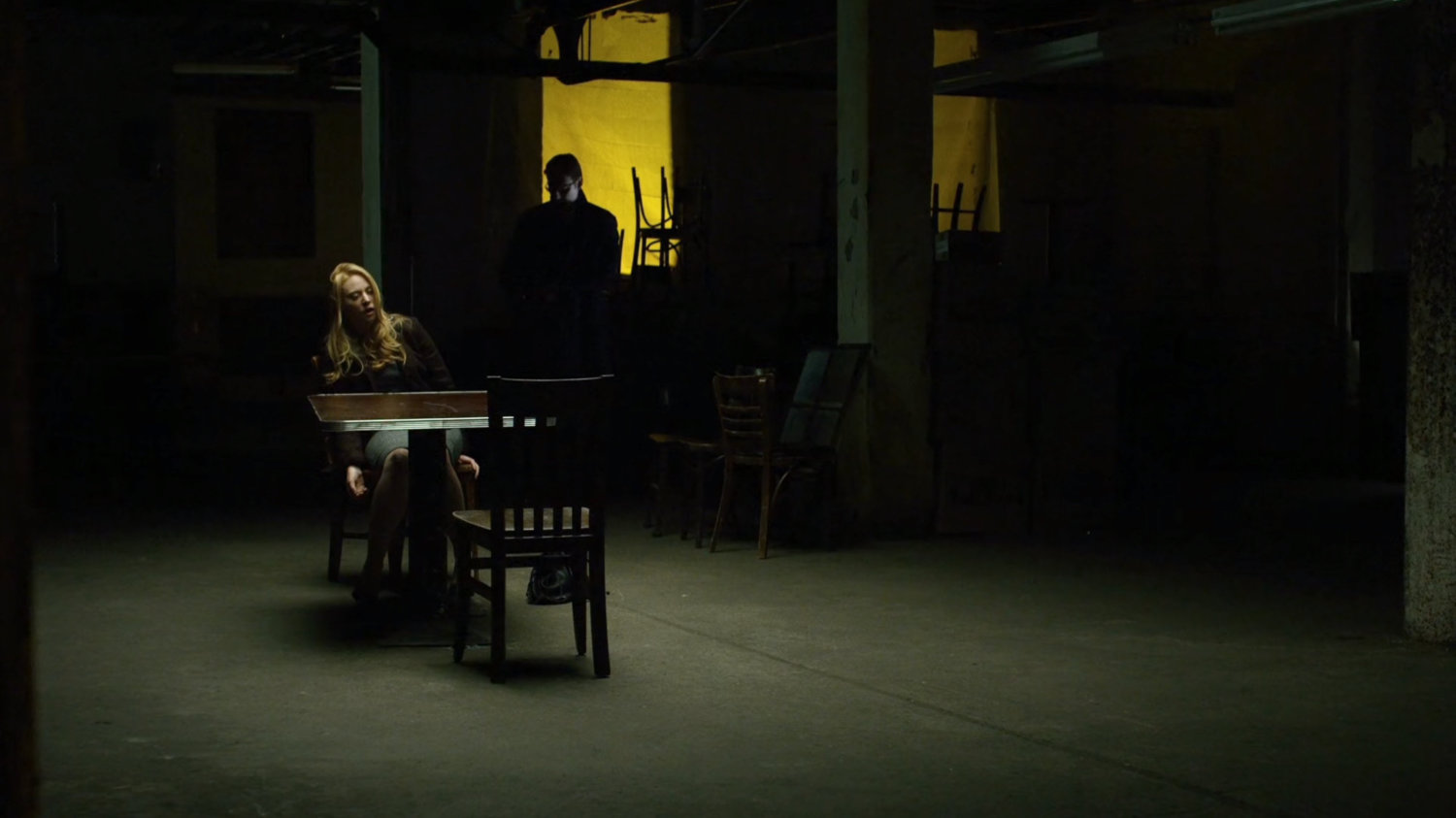 Wesley and Karen in dark basement.