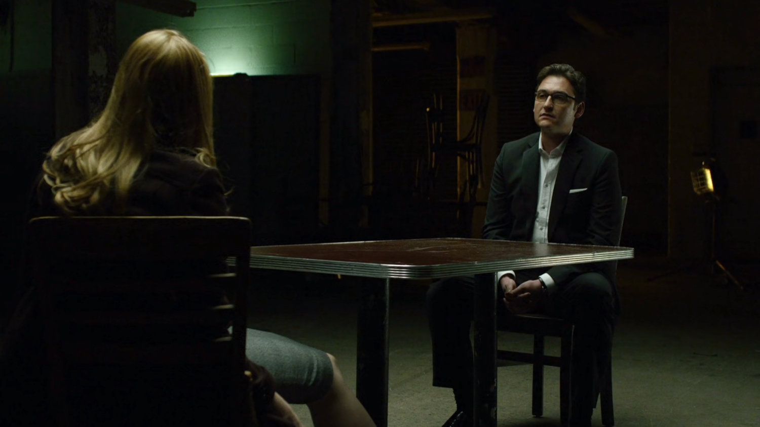 Wesley and Karen in dark basement.