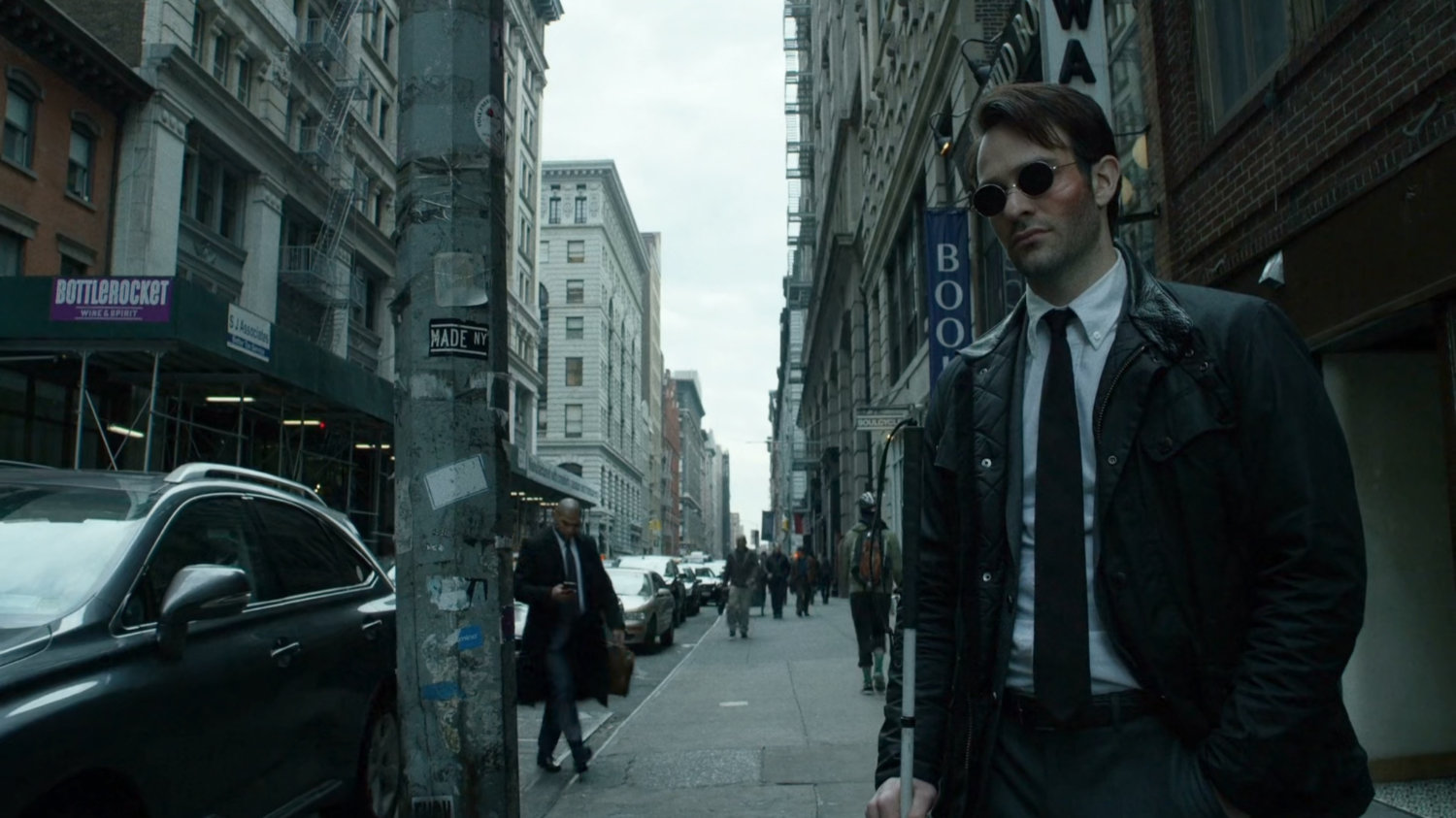 Matt on sidewalk of traffic packed New York street.