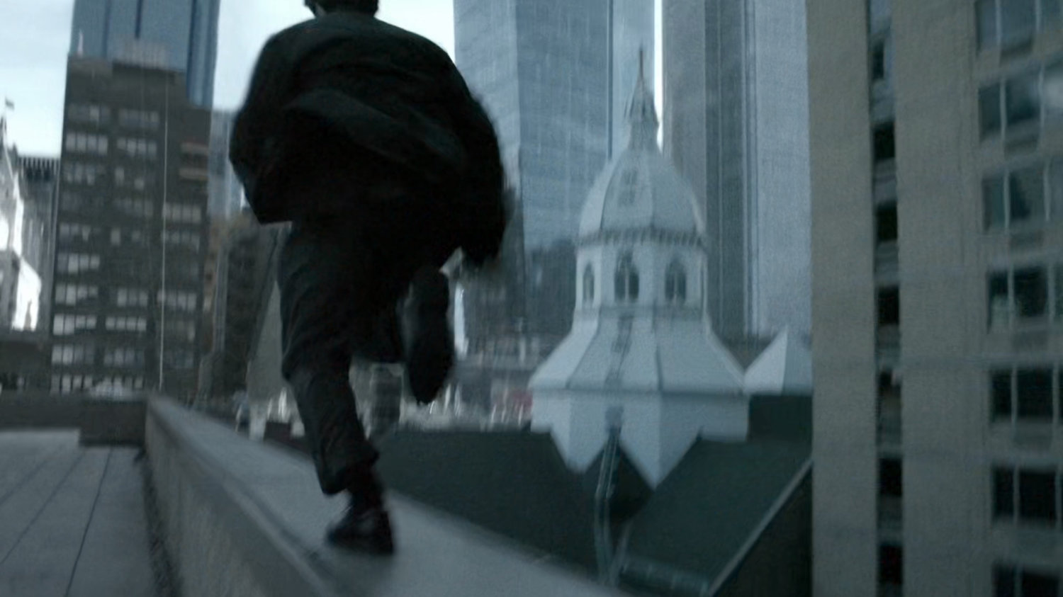 Matt runs across ledge of New York rooftop.