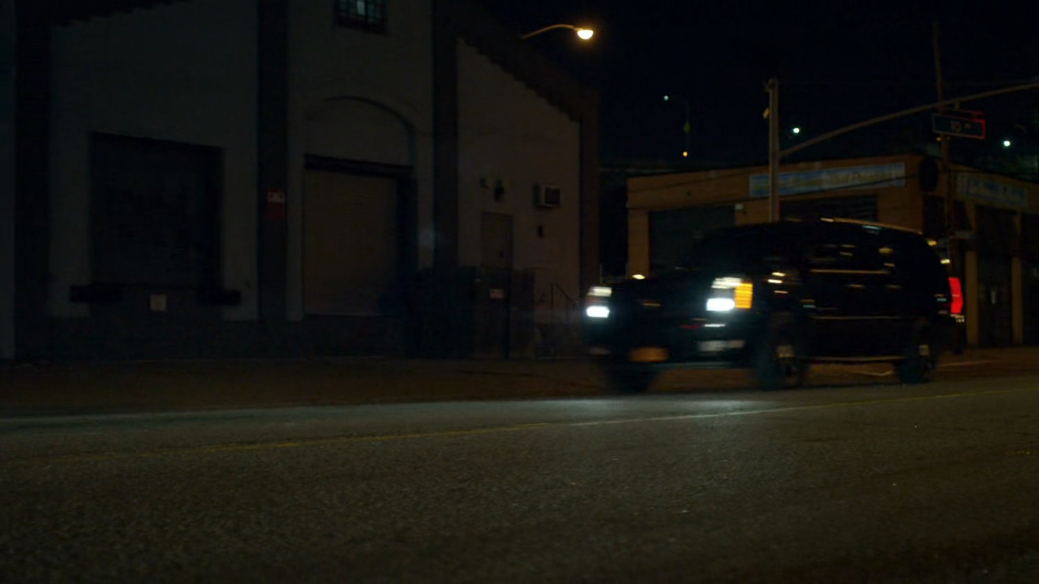 Fisk's motorcade driving on a dark street.