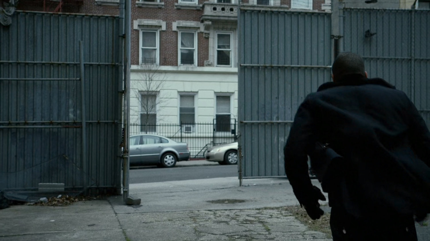 Turk runs towards street from alley.