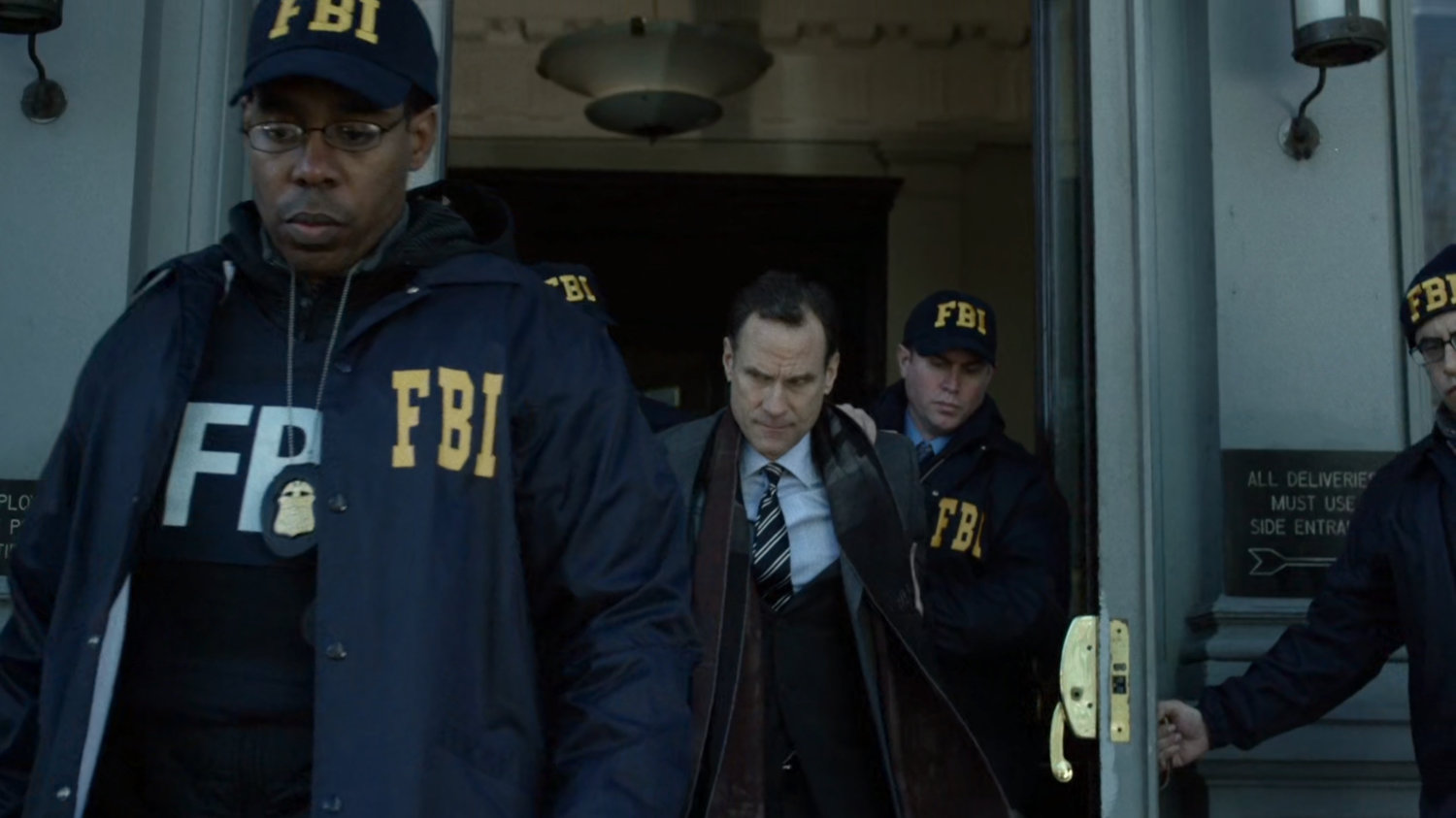 FBI agents exiting Senator's office building.