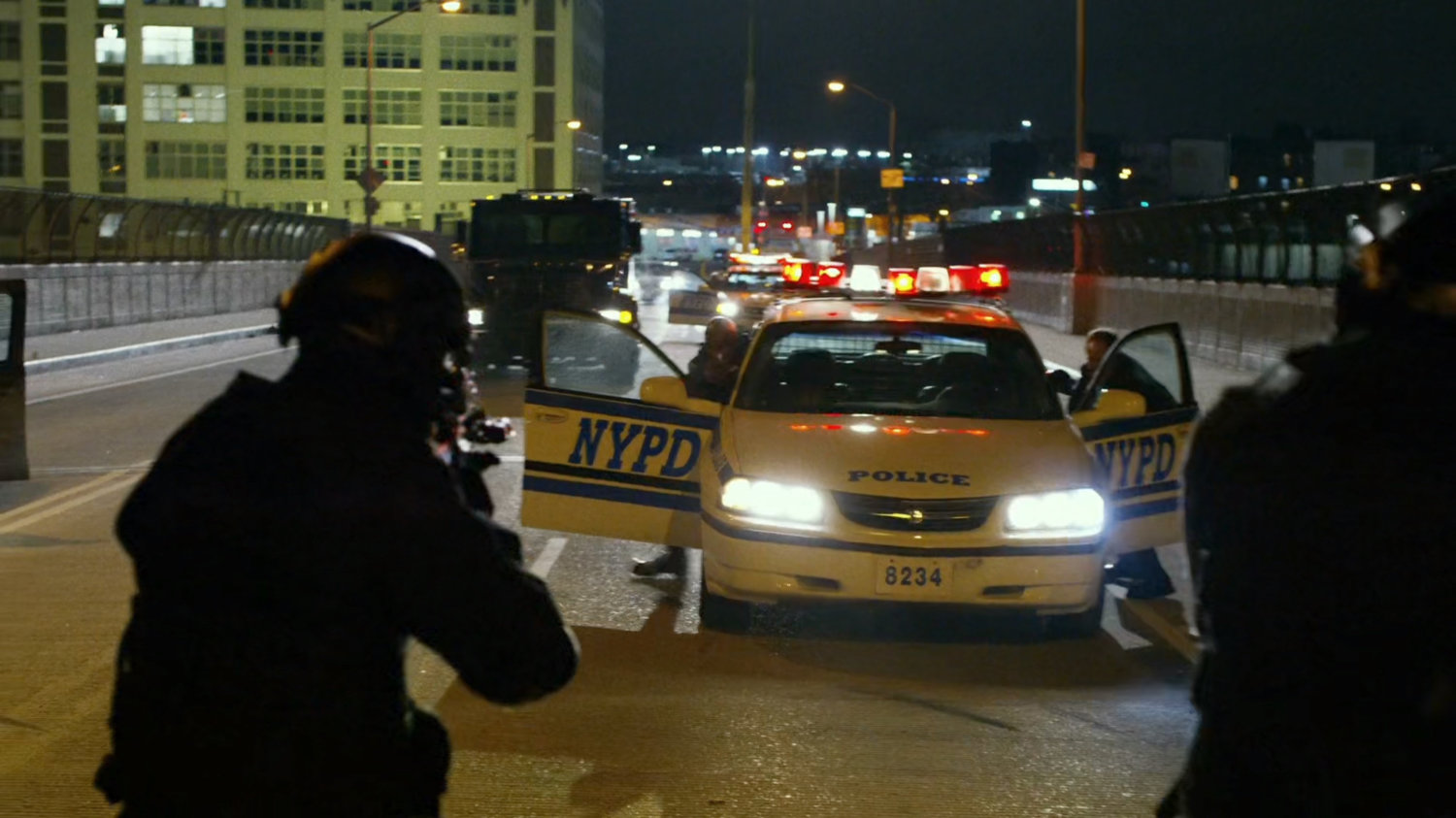 Armed gunman take aim against police vehicles.