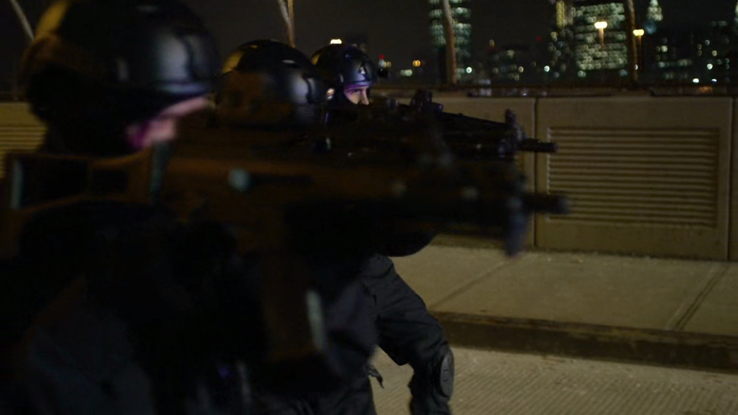Armed gunman take aim against police vehicles.