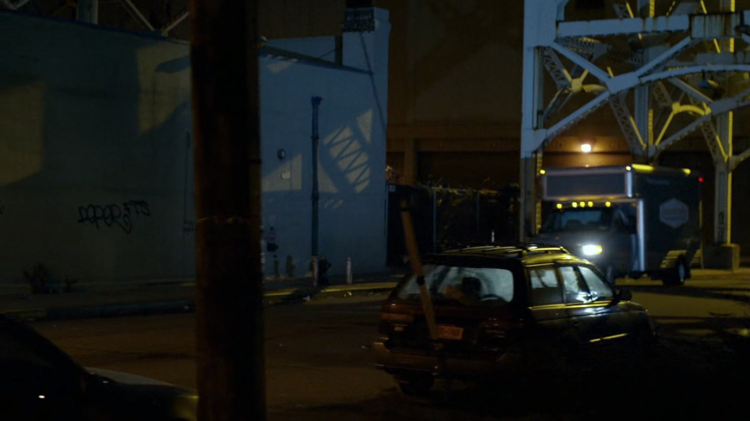 Truck driving along city street.