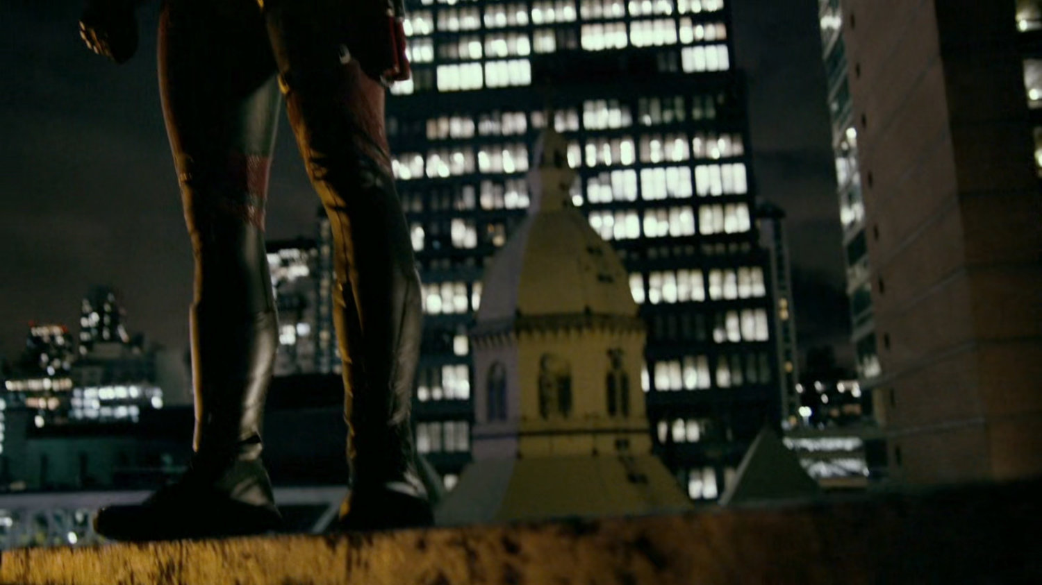 Daredevil standing on a roof.