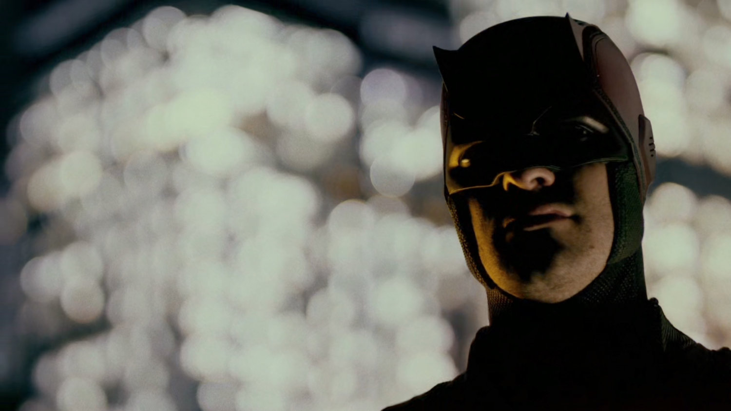 Closeup of Daredevil standing on a roof.