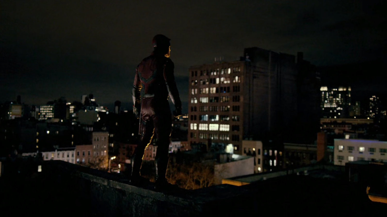 Daredevil standing on a roof.