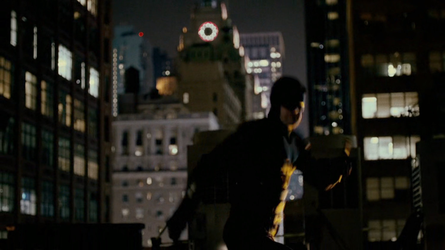 Daredevil standing on a roof.