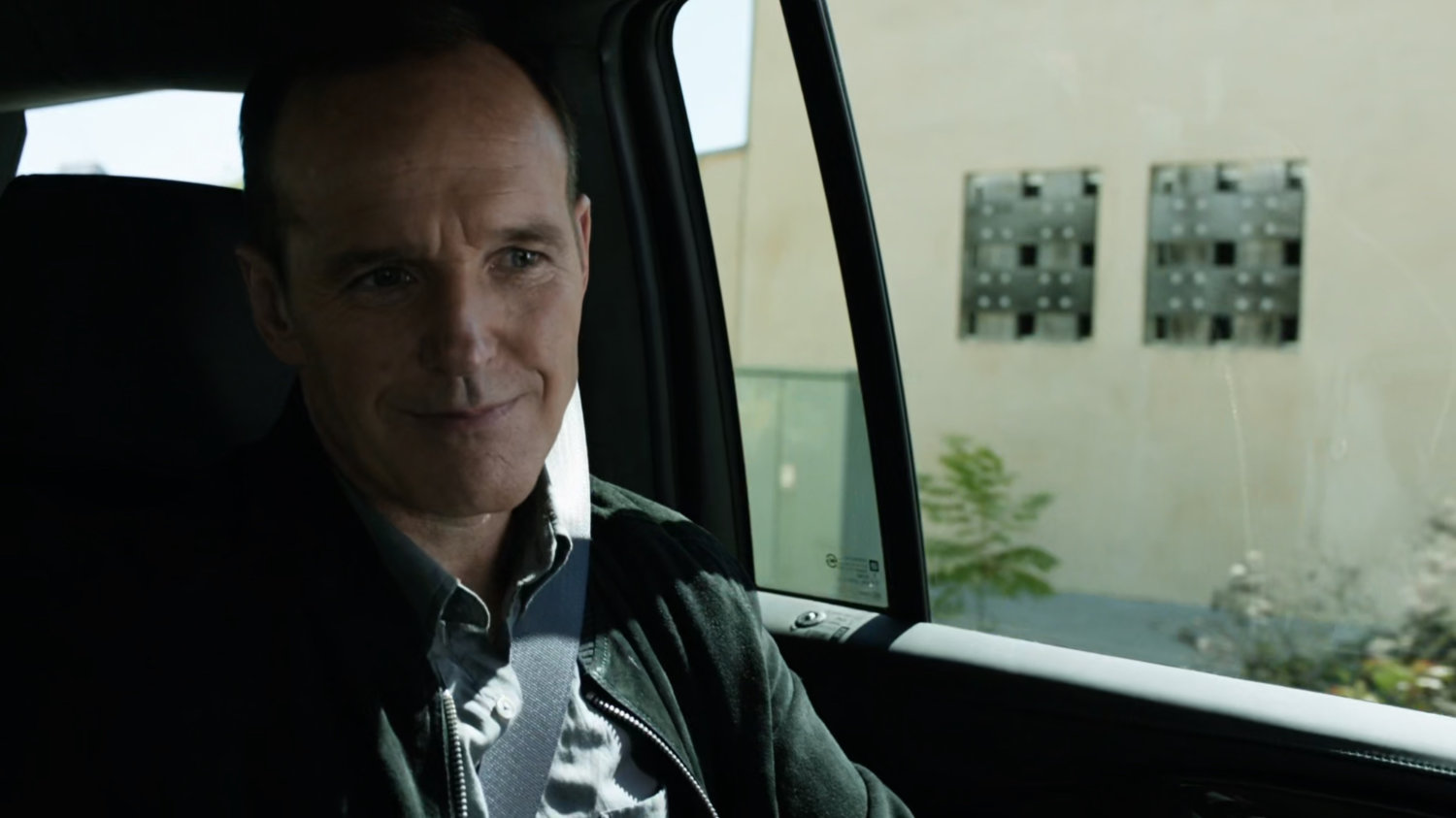 Coulson inside car on Washington DC street.