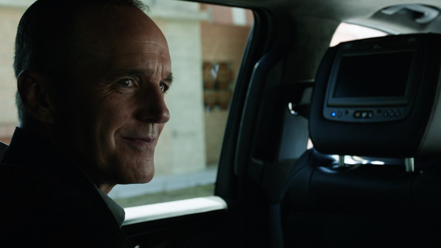 Coulson inside car on Washington DC street.