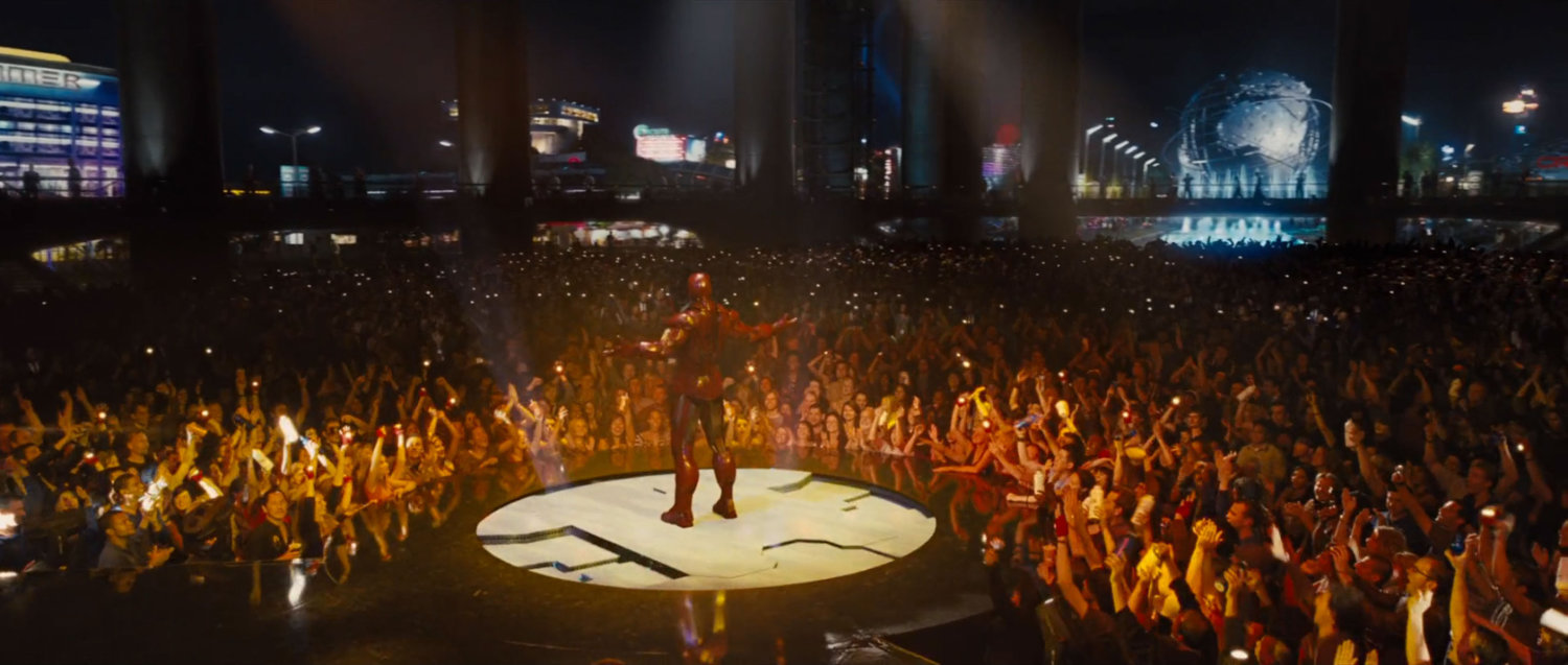 Iron Man stands in front of a crowd at the Stark Expo Main pavilion.