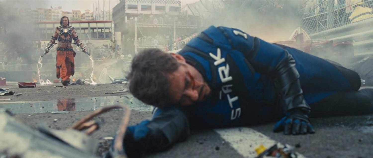Tony Stark laying in debris on the race track.
