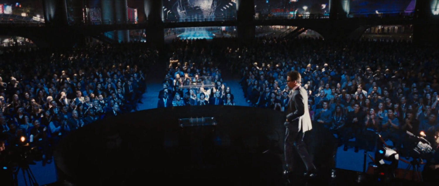 Justin Hammer stands in front of a crowd at the Stark Expo Main pavilion.