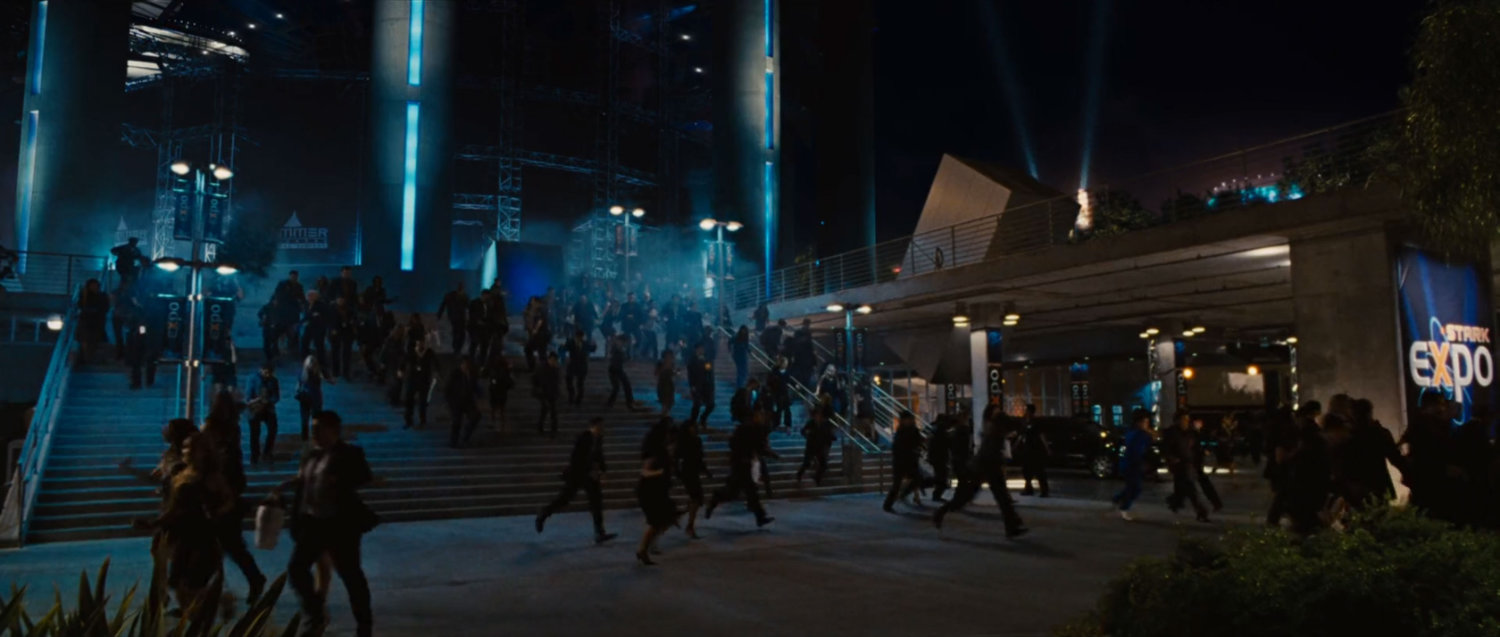 Crowds flee down exterior stairs at the Stark Expo.