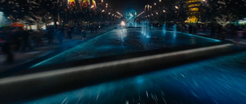 Nighttime exterior of the Stark Expo main entrance and fountains.